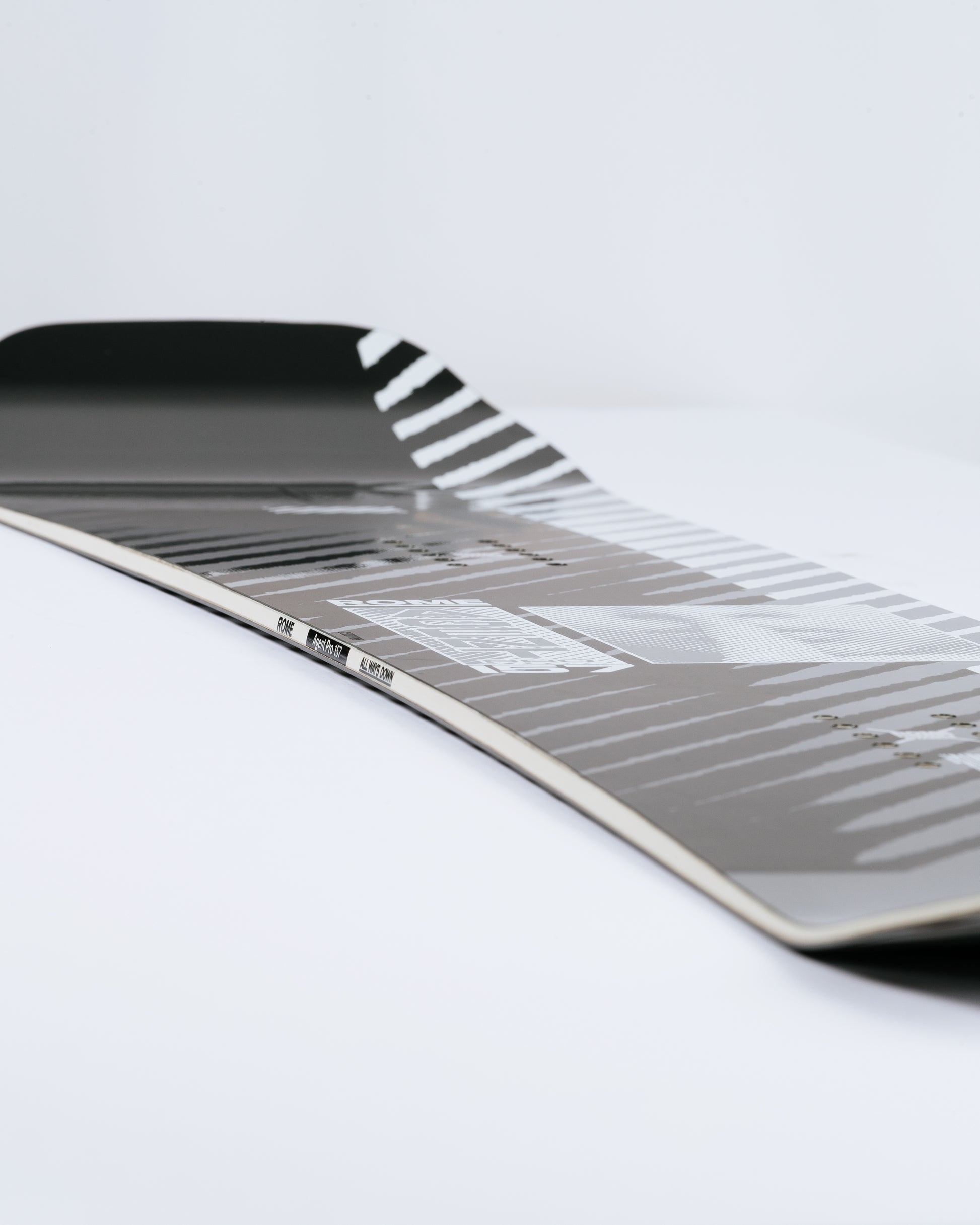 Photograph showing freestyle snowboard with fusion camber. Agent Pro 2025 | Rome Snowboards™ 2025.