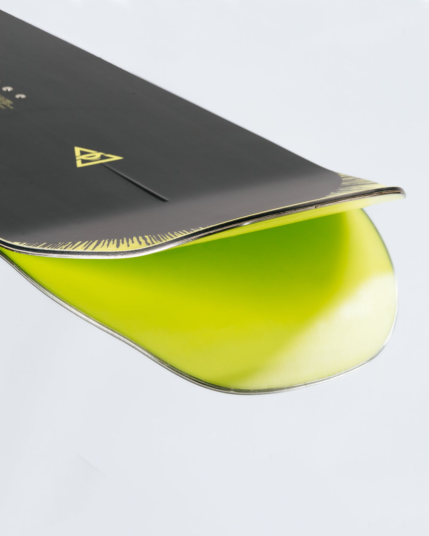 The tail and base of the freestyle snowboard with HotRods and PowerSlide base.  Artifact 2025 | Rome Snowboards™ 2025.