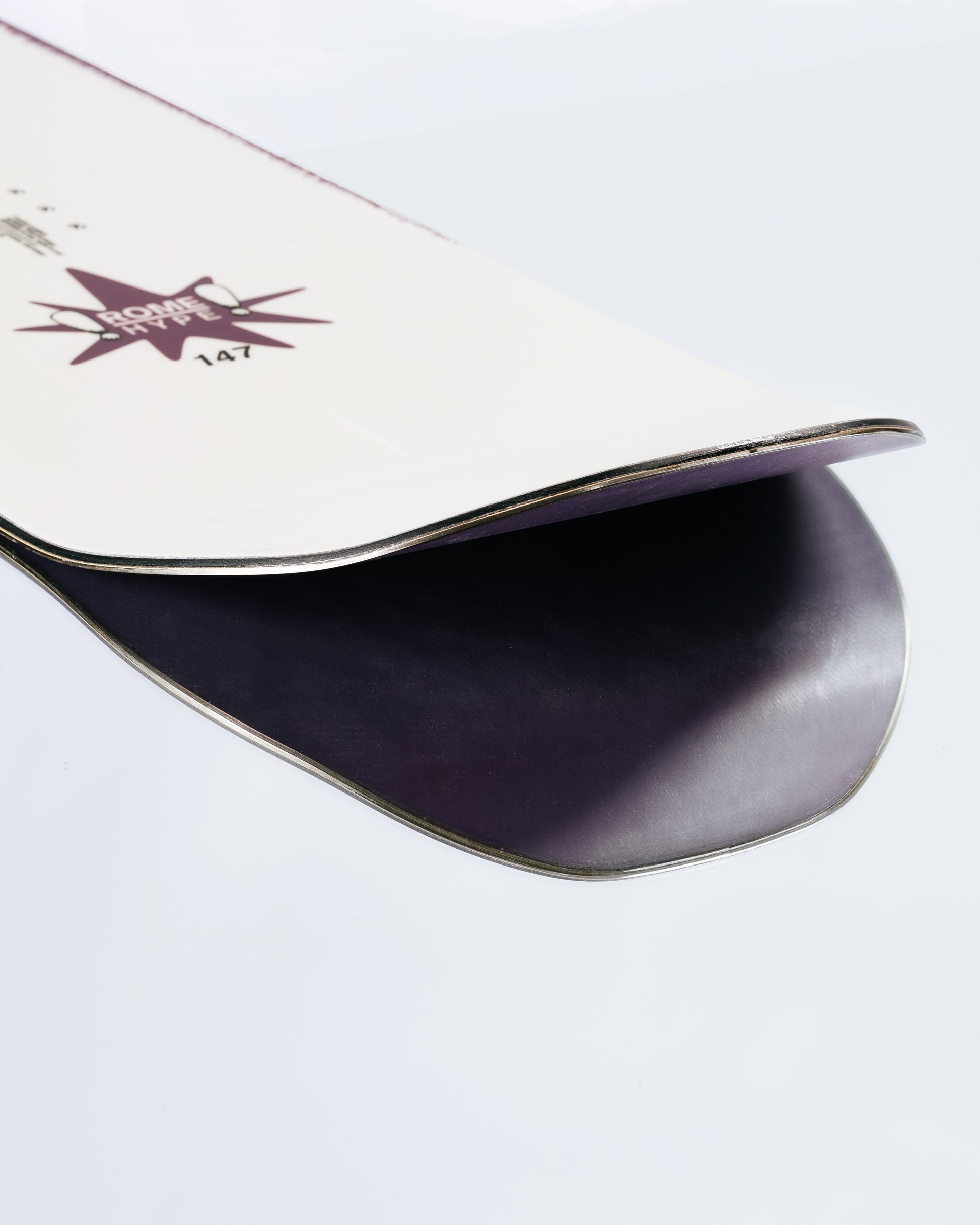 The tail and base of the freestyle womens snowboard with HotRods and Impact base. Hype 2025 | Rome Snowboards™ 2025.